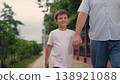 happy family, father son walking together in park, parent hold child hand in park, man with child boy outdoors walking together, boy kid child play with parent looking, play outdoors, fun walk child 138921088
