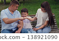 man woman play child boy park, happy family, teamwork, handshake fists, child play dad fist, hand fist, boy child man father smile looking into eyes, friendly team, friendly child game, smile kid dad 138921090
