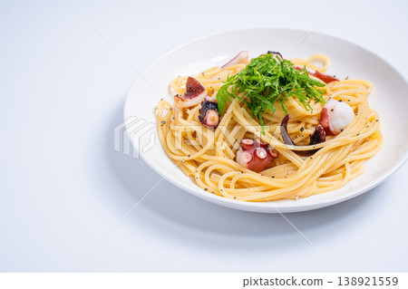 Japanese-style pasta with octopus and perilla leaves, simply seasoned spaghetti, white background Japanese-style pasta with octopus and perilla leaves, simply seasoned spaghetti, white background 138921559