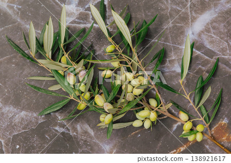 Fresh green olives harvest on marble table with copy space. Mediterranean agricultural concept Fresh green olives harvest on marble table with copy space. Mediterranean agricultural concept 138921617