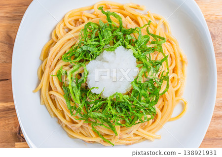 Japanese-style tuna pasta with refreshing spaghetti topped with shiso leaves and grated daikon radish. Japanese-style tuna pasta with refreshing spaghetti topped with shiso leaves and grated daikon radish. 138921931