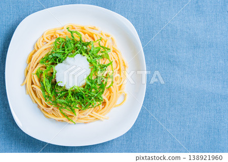 Japanese-style tuna pasta with refreshing spaghetti topped with shiso leaves and grated daikon radish. Japanese-style tuna pasta with refreshing spaghetti topped with shiso leaves and grated daikon radish. 138921960
