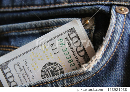 Dollar money in the pocket of jeans. Banknote One hundred dollar. 138921988