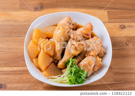 Braised chicken wings and daikon radish - a traditional Japanese home-style dish. Braised chicken wings and daikon radish - a traditional Japanese home-style dish. 138922122