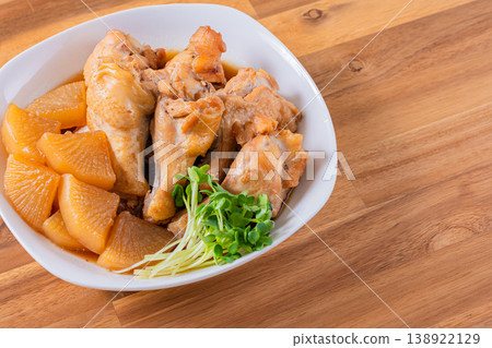 Braised chicken wings and daikon radish - a traditional Japanese home-style dish. Braised chicken wings and daikon radish - a traditional Japanese home-style dish. 138922129