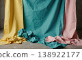 Paper backdrops studio featuring colorful torn and crumpled remnants lying on a concrete floor in a creative photography workspace 138922177