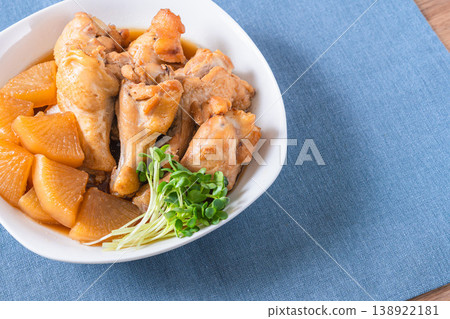 Braised chicken wings and daikon radish - a traditional Japanese home-style dish. Braised chicken wings and daikon radish - a traditional Japanese home-style dish. 138922181