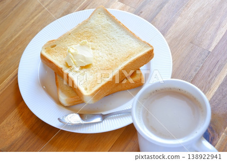 Toast and coffee (café au lait) - A breakfast table with freshly baked toast and freshly brewed café au lait. Toast and coffee (café au lait) - A breakfast table with freshly baked toast and freshly brewed café au lait. 138922941