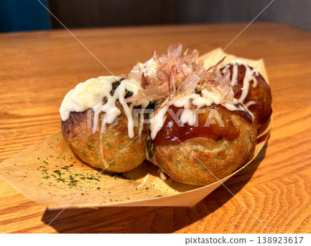 Takoyaki - A frontal angle where the bonito flakes are clearly visible. Takoyaki - A frontal angle where the bonito flakes are clearly visible. 138923617