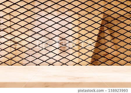 Marble Table with Black Metal Mesh Screen Background in Beige Tone. Marble Table with Black Metal Mesh Screen Background in Beige Tone. 138923993