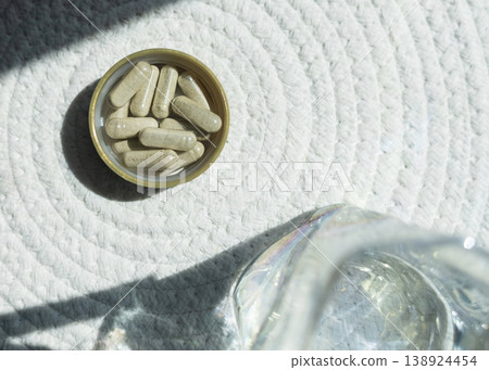 Close-up of iron supplement capsules in a lid for iron deficiency anemia treatment. Health care, wellness, and dietary supplements for daily vitamins and minerals intake. Close-up of iron supplement capsules in a lid for iron deficiency anemia treatment. Health care, wellness, and dietary supplements for daily vitamins and minerals intake. 138924454