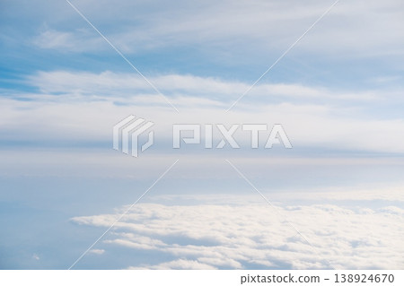 The contrast between the vast sea of clouds covering the sky and the blue sky. The contrast between the vast sea of clouds covering the sky and the blue sky. 138924670
