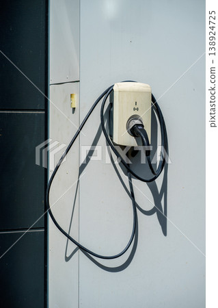 Electric vehicle charging wall box with cable connected,EV infrastructure, clean energy solution, modern technology for sustainable transport mobility Electric vehicle charging wall box with cable connected,EV infrastructure, clean energy solution, modern technology for sustainable transport mobility 138924725