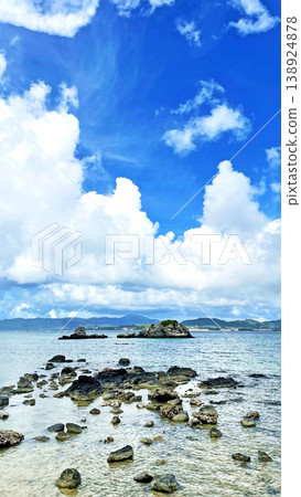 Okinawa, Taketomi Island: The coast of Mishashi and dynamic cumulonimbus clouds floating in the summer sky. Okinawa, Taketomi Island: The coast of Mishashi and dynamic cumulonimbus clouds floating in the summer sky. 138924878