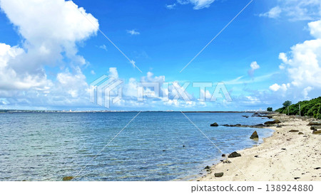 Okinawa, Taketomi Island: The coast of Mishashi and dynamic cumulonimbus clouds floating in the summer sky. 138924880