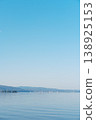 Mountains reflected on the tranquil surface of the lake, a waterside landscape woven from moonlight and islands. 138925153