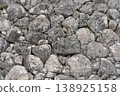 A timeless stone wall woven from moss-covered boulders. 138925158