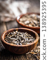 Sunflower Seeds in Bowl on Wooden Table With Scattered Shells Rustic Snack Background 138925395