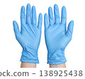 Hands wearing blue medical latex gloves isolated on a white background 138925438