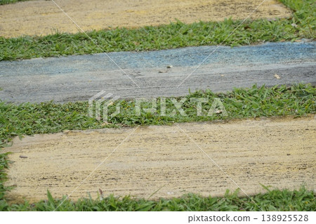 Walkway with a green and yellow border Walkway with a green and yellow border 138925528