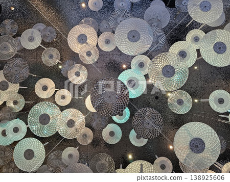 Cluster of white and blue lights are suspended from the ceiling Cluster of white and blue lights are suspended from the ceiling 138925606