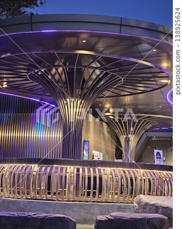 Large, curved structure with purple lights shining on it Large, curved structure with purple lights shining on it 138925624