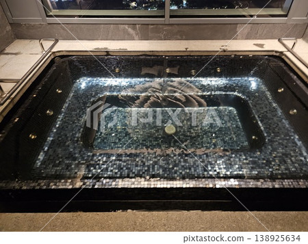 Black bathtub with a large flower design on the bottom Black bathtub with a large flower design on the bottom 138925634