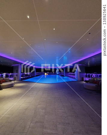 Large pool with a blue lighted ceiling 138925641