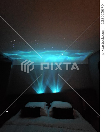 Bed with a blue light shining on it Bed with a blue light shining on it 138925670