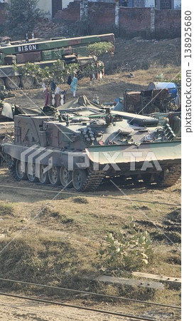Military tank is driving through a field Military tank is driving through a field 138925680