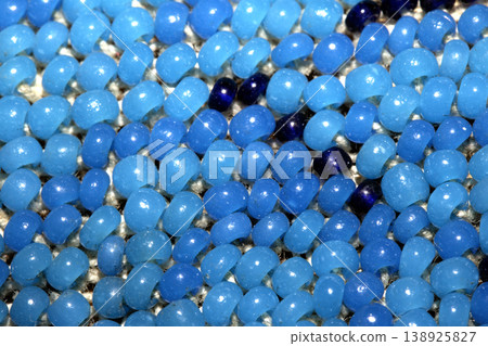 Cute craft small glass beads in an abstract pattern for background Cute craft small glass beads in an abstract pattern for background 138925827