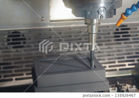 Rough cutting process of a graphite electrode using a flat nose end mill tool on a CNC milling machine. Rough cutting process of a graphite electrode using a flat nose end mill tool on a CNC milling machine. 138926467