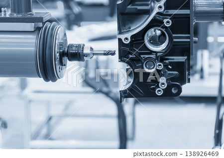 Industrial robotic arm with flat nose end mill finishing an automotive aluminum gear case part. Industrial robotic arm with flat nose end mill finishing an automotive aluminum gear case part. 138926469