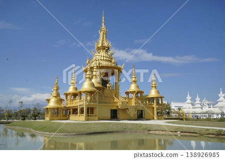 Large gold building with a gold roof and gold spires Large gold building with a gold roof and gold spires 138926985