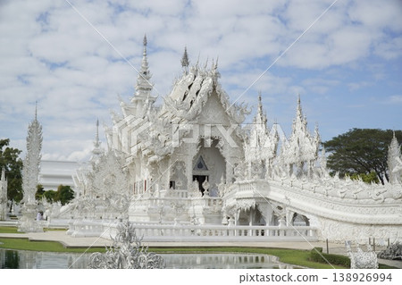 White building with a lot of white details and a white roof White building with a lot of white details and a white roof 138926994