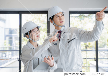 A young man and a woman in work clothes A young man and a woman in work clothes 138927303