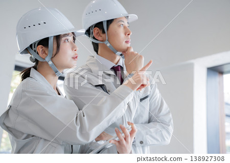 A young man and a woman in work clothes 138927308