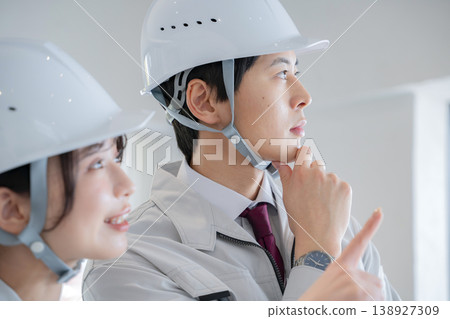 A young man and a woman in work clothes 138927309