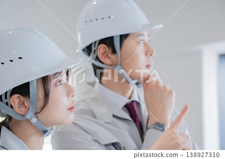 A young man and a woman in work clothes 138927310
