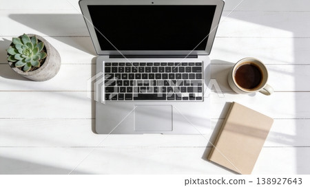 Clean White Desk Workspace with Laptop and Black Coffee 138927643