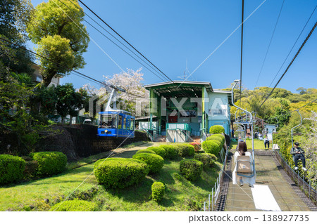 Ehime Prefecture: Matsuyama Castle Ropeway and Lift running side-by-side, a spring scene of ascending to the castle amidst blooming cherry blossoms. 138927735