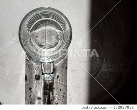 A composition with a mug of pure water. Abstraction with caustics 138927938