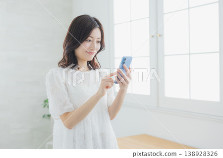 A woman watching a smartphone 138928326