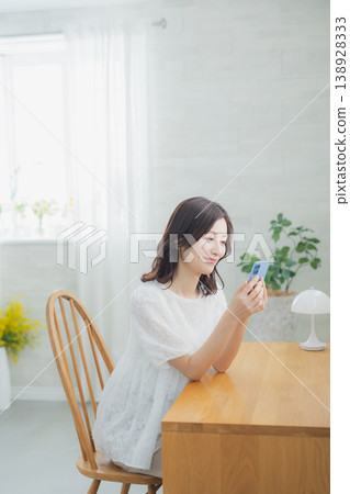 A woman watching a smartphone A woman watching a smartphone 138928333