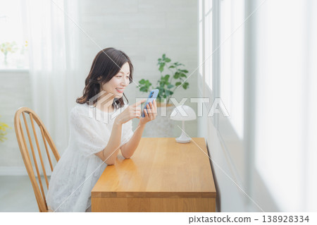 A woman watching a smartphone 138928334