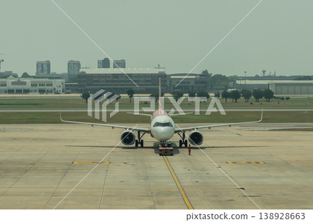 Aircraft on Airport Runway Ready for Departure Surrounded by Airport Infrastructure and Clear Sky Environment Aircraft on Airport Runway Ready for Departure Surrounded by Airport Infrastructure and Clear Sky Environment 138928663