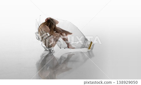 Woman trapped inside crushed plastic bottle symbolizing environmental and mental pressure. Woman trapped inside crushed plastic bottle symbolizing environmental and mental pressure. 138929050