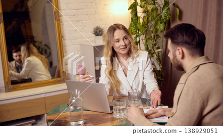 Mental coach guiding client through notes and emotional discussion session. 138929051