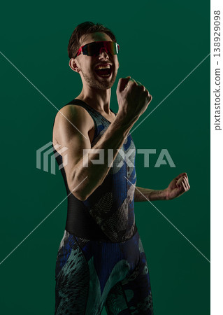 Close up male athlete celebrating victory with clenched fist and open mouth expression Close up male athlete celebrating victory with clenched fist and open mouth expression 138929098