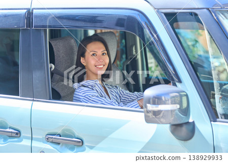 Japanese woman in the driver's seat of a car 138929933